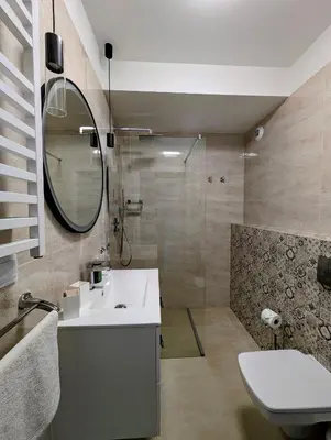 a bathroom with a sink and a mirror and a shower at Kościuszki 22 by Homeprime in Kraków