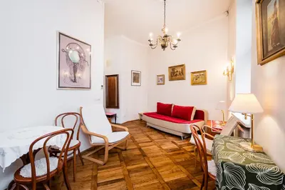 a living room with a table and chairs and a couch at Old City Old Style Studio in Kraków