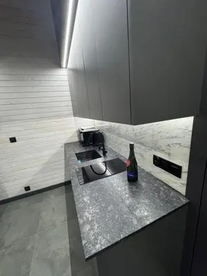 a kitchen with a counter with a bottle on it at Zacisze Mogielicy-Domki w Beskidzie Wyspowym in Półrzeczki