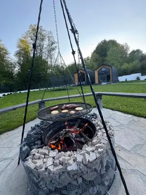 a swing around a fire pit in a yard at Zacisze Mogielicy-Domki w Beskidzie Wyspowym in Półrzeczki