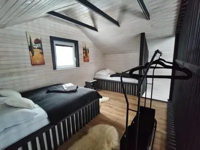 a room with two beds and a window in it at Zacisze Mogielicy-Domki w Beskidzie Wyspowym in Półrzeczki