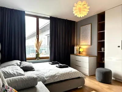 a bedroom with a bed and a large window at Masarska Apartment - Self Check-In 20h - Parking&Lift in Kraków