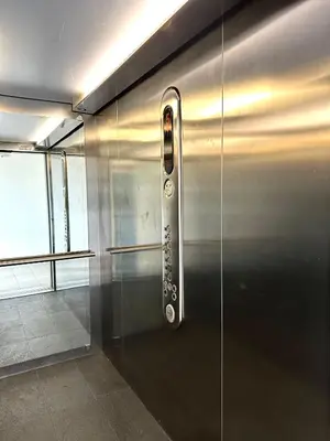 a metal door with a remote control on it at Masarska Apartment - Self Check-In 20h - Parking&Lift in Kraków
