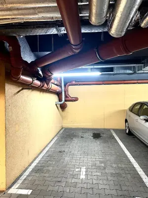 a car parked in a parking lot with pipes at Masarska Apartment - Self Check-In 20h - Parking&Lift in Kraków