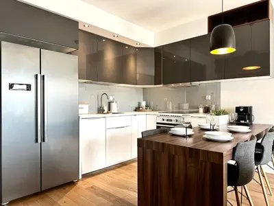 a kitchen with stainless steel appliances and a wooden island at Masarska Apartment - Self Check-In 20h - Parking&Lift in Kraków
