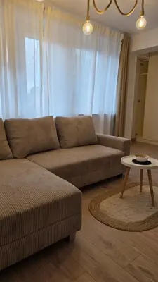 a living room with a couch and a table at Apartament Boho 23 in Kraków