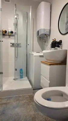 a bathroom with a shower and a toilet and a sink at Apartament Boho 23 in Kraków