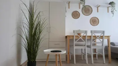 a living room with a dining room table and chairs at Apartament Boho 23 in Kraków