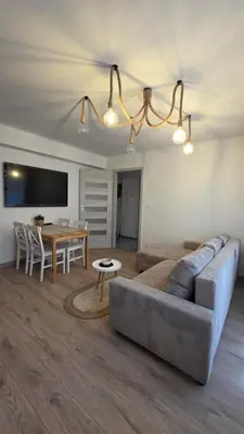 a living room with a couch and a table at Apartament Boho 23 in Kraków