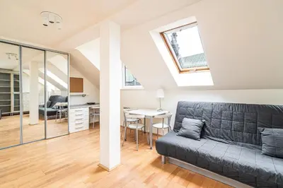 a living room with a couch and a table at RentPlanet - Apartament Garbarska in Kraków