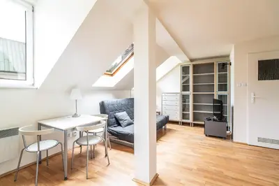 a living room with a table and chairs and a couch at RentPlanet - Apartament Garbarska in Kraków