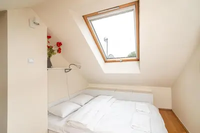 a bed in a room with a window at RentPlanet - Apartament Garbarska in Kraków