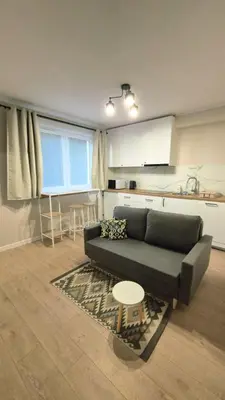 a living room with a couch and a table at Apartament na Wzgórzu 2 in Bochnia