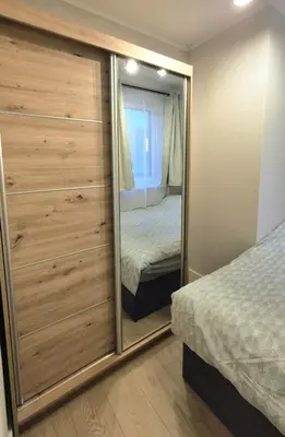 a bedroom with a mirror and a bed in it at Apartament na Wzgórzu 2 in Bochnia