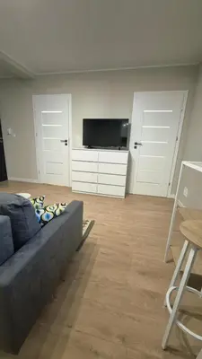 a living room with a couch and a flat screen tv at Apartament na Wzgórzu 2 in Bochnia