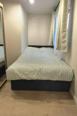 a small bed in a bedroom with a window at Apartament na Wzgórzu 2 in Bochnia