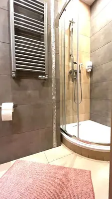 a bathroom with a shower with a glass door at Studio for One in Kraków