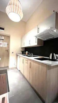 a kitchen with a sink and a stove top oven at Studio for One in Kraków