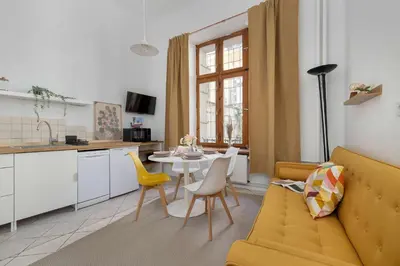 a living room with a couch and a table at Charming Apartment with Mezzanine near Old Town in Cracow by Noclegi Renters in Kraków