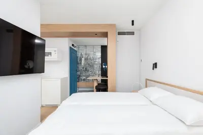 a bedroom with a white bed and a table at City of the Kings-Riverside K22M31 in Kraków