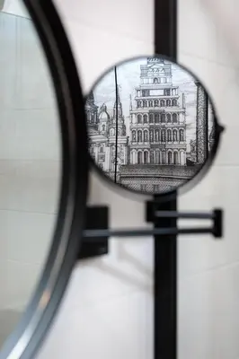 a reflection of a building in a magnifying glass at City of the Kings-Riverside K22M31 in Kraków