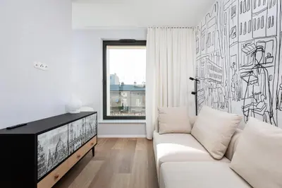 a living room with a white couch and a tv at City of the Kings-Riverside K22M31 in Kraków