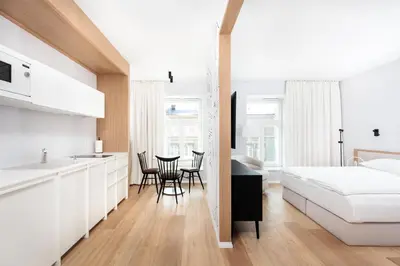 a bedroom with a bed and a table and chairs at City of the Kings-Riverside K22M16 in Kraków