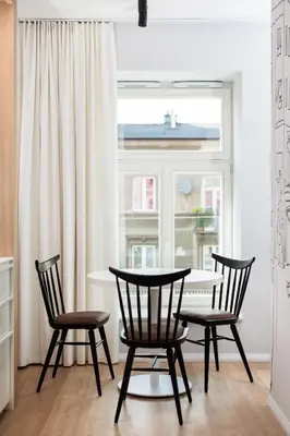 a dining room with a table and chairs and a window at City of the Kings-Riverside K22M16 in Kraków