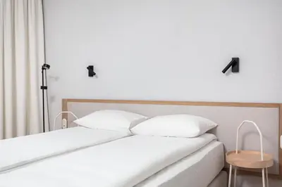 a bedroom with two white pillows on a bed at City of the Kings-Riverside K22M16 in Kraków