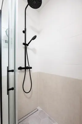 a shower with a shower head in a bathroom at City of the Kings-Riverside K22M16 in Kraków