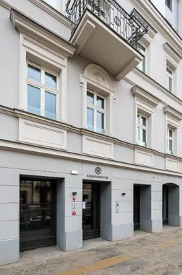 a white building with windows and a balcony at City of the Kings-Riverside K22M16 in Kraków