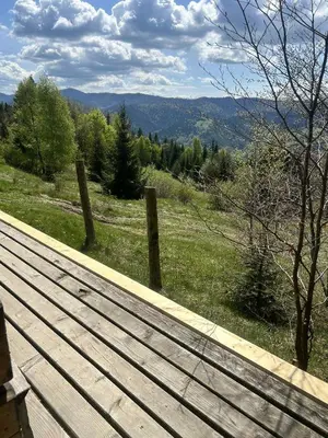 a wooden boardwalk with a view of a mountain at Samotnia w Górach Odludzie Domek in Ochotnica Górna