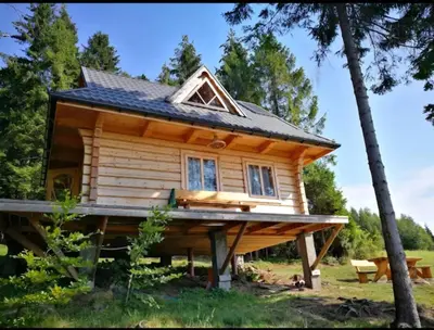 a tiny house on a large wooden platform at Samotnia w Górach Odludzie Domek in Ochotnica Górna