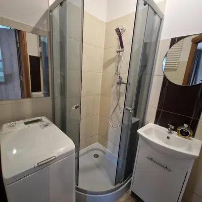 a bathroom with a shower and a toilet and a sink at Apartament Anna in Kraków