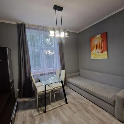 a living room with a table and a couch at Apartament Anna in Kraków