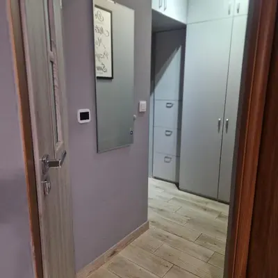 an empty hallway with a door and a mirror at Apartament Anna in Kraków