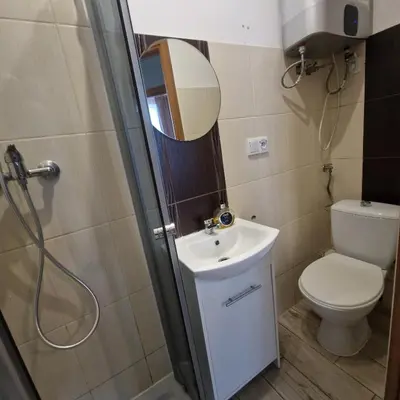 a bathroom with a toilet and a sink and a shower at Apartament Anna in Kraków