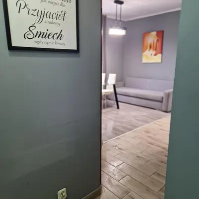 a door leading into a living room with a couch at Apartament Anna in Kraków