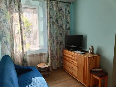 a bedroom with a bed and a tv on a dresser at Pokoje, apartamenty 1km od Energylandii in Zator