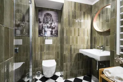a bathroom with a toilet and a sink at Horizon Apartments - Zamenhofa in Kraków