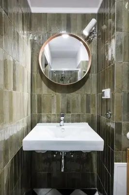 a bathroom with a sink and a mirror at Horizon Apartments - Zamenhofa in Kraków