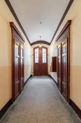 an empty hallway with two doors and a hallwayngth at Horizon Apartments - Zamenhofa in Kraków
