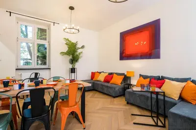a living room with a couch and a table at Horizon Apartments - Zamenhofa in Kraków