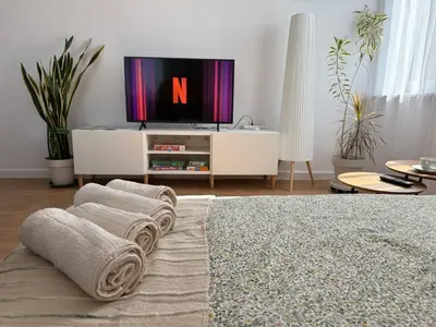 a living room with a tv and towels at Apartament Żabie Oczko in Zator