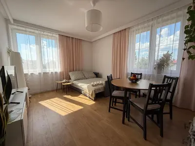 a living room with a table and a couch at Apartament Żabie Oczko in Zator