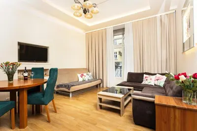 a living room with a couch and a table at Apartament Vinci in Kraków