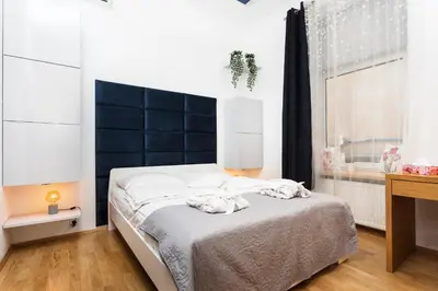 a bedroom with a bed with towels on it at Apartament Vinci in Kraków