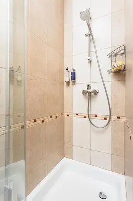 a bathroom with a shower and a tub at Apartament Vinci in Kraków