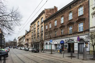 a city street with buildings and cars parked on the street at Apartament Vinci in Kraków