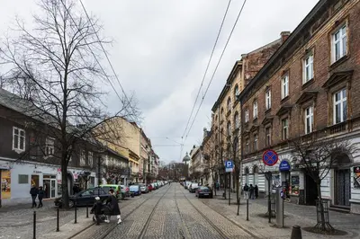 a city street with buildings and people walking down the street at Apartament Vinci in Kraków